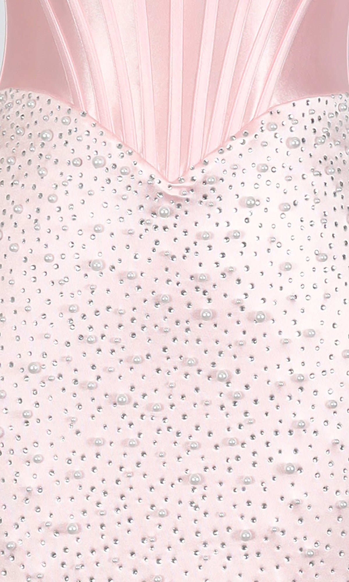 Close-up of the Short Homecoming Dress: PromGirl Exclusive 250344 featuring a pink satin corset bodice with vertical seams, adorned with scattered pearls and rhinestones.